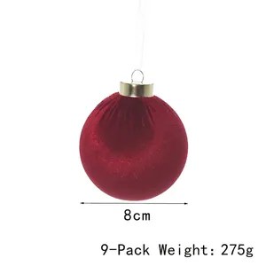 Close-up detail of 8cm red velvet Christmas ornament ball showing size and weight