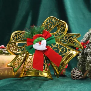 Close-up detail of a festive golden bow Christmas ornament with Santa Claus
