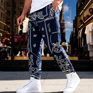 Side detail view of men's blue bandana print cargo pants in hip hop street style.