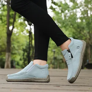 Side view of light blue high-top casual slip-on shoes with hand-stitched details