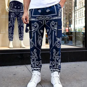 Detail of navy blue paisley print cargo pants for men with a tapered hip-hop style