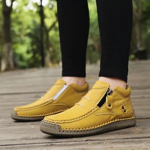 Detailed view of yellow handmade leather casual shoes featuring side zipper and white stitching