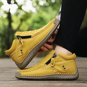 Detailed view of yellow high-top outdoor casual shoes with handmade stitching and zipper