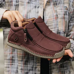 Close-up of high-top leather casual shoes with side zipper and handmade stitching.