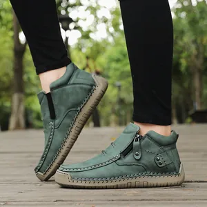 Close-up detail of green high-top outdoor casual shoes with functional side zipper