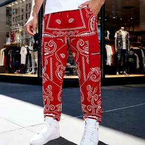 Detailed view of red paisley print cargo pants with side pockets and zippers