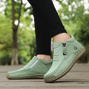 Close-up side view of mint green high-top outdoor casual shoes with handmade stitching
