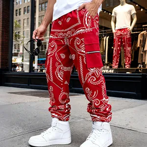 Close-up of red bandana print cargo pants with streetwear styling and pocket detail