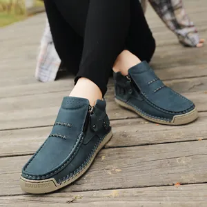 Close-up view of blue handmade high-top casual leather shoes with a side zipper