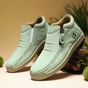 Close-up detail of mint green high-top casual outdoor shoes displayed on a mossy log