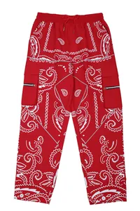 Red paisley print cargo pants with drawstring waist in a relaxed hip hop street style.