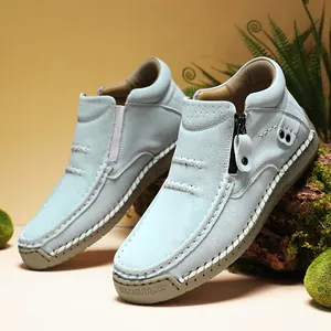 Detail view of light blue high-top outdoor casual shoes with zipper and stitching