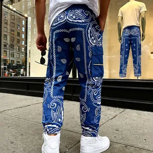 Back view of men's blue paisley print cargo pants in American West Coast street style.