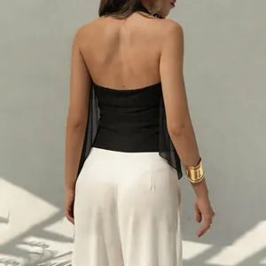 Back view of a chic black backless halter top featuring an irregular sheer hemline