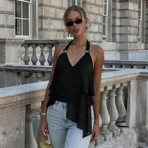 Chic black halter v-neck ruffled top with irregular hem styled in classical setting