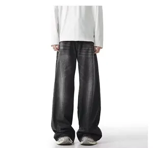 Detailed view of men's loose wide-leg washed black jeans with vintage distressed finish
