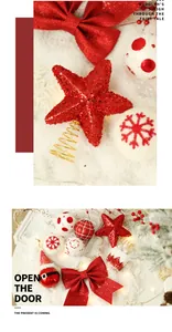Close-up of glittery red Christmas tree star topper and red bow on snowy background