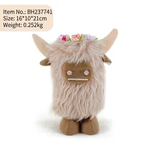Detailed view of long-haired highland cow plush toy with a colorful floral crown.