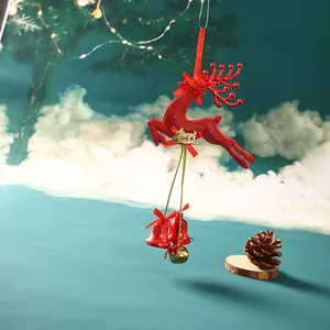 Detailed macro view of a glittery red Christmas reindeer ornament featuring hanging bells and ribbon