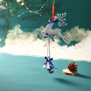 Macro view of silver reindeer Christmas ornament with blue bows and jingle bells