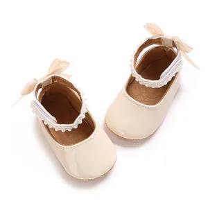 Elegant cream baby girl princess shoes with pearl ankle strap and bow detail.
