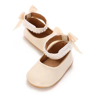 Detail view of cream PU baby princess shoes with pearl straps and bow accents