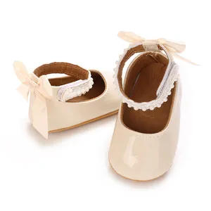 Soft beige PU patent baby girl princess shoes featuring pearl straps and silk bows