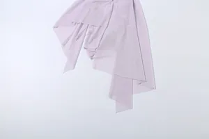 Close-up detail of the flowy asymmetrical layered mesh hem on a lavender camisole