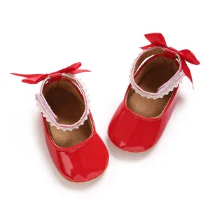 Macro view of red PU patent leather baby princess shoes featuring pearl straps and satin bows