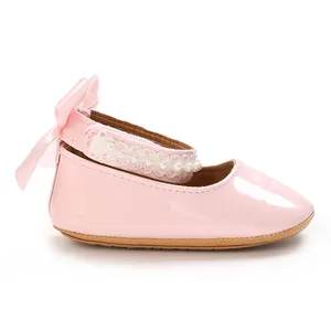 Side detail of pink patent leather baby girl princess shoes with decorative pearls