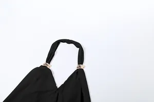 Close-up of sexy black halter neck top with stylish gold ring buckle detail on strap