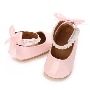 Close-up detail of pink patent PU baby girl princess shoes with pearls and bows