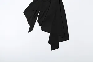 Detail view of black irregular draped hem on a sexy halter camisole vest