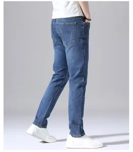 Detailed side view of men's slim straight blue stretch jeans with back pocket design.