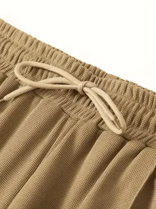 Detailansicht der khakifarbenen Waffelstrickhose mit elastischem Kordelzug am Bund
