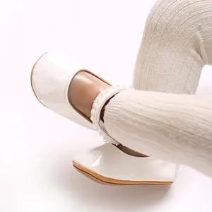 Detail of white PU leather baby princess shoes featuring elegant pearl ankle strap.