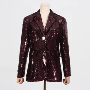 Detailed view of women's sparkly burgundy sequin blazer with black lapel contrast