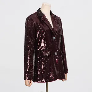 Detail view of a wine red sequined women's blazer with black lapel and button detail.