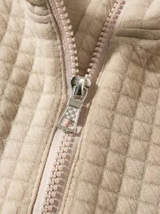 Detailansicht des silbernen Reißverschlusses und der Waffelstrick-Struktur bei diesem Sweatshirt