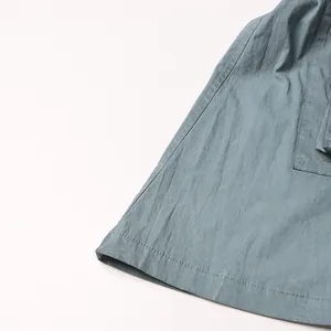 Detail view of the hem and textured fabric of high-waisted micro-flare pants
