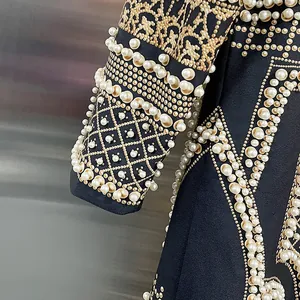 Dettaglio ravvicinato di un cappotto lungo da donna con perle e stampa leopardata