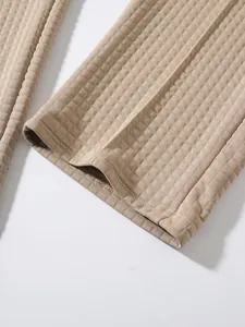 Macro detail of waffle knit fabric texture and hem on beige men's casual pants