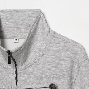 Close-up of grey zip-up jacket collar showing metal zipper and texture.