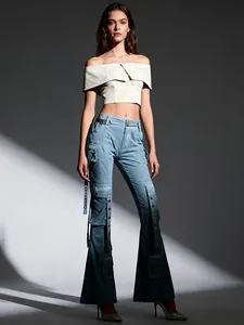 Stylish high-waisted flared denim cargo pants with gradient blue design and straps.