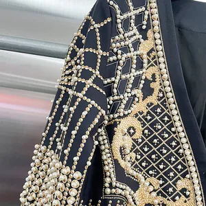 Dettaglio di un blazer nero di lusso con perline intricate e ricami dorati