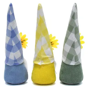 Detailed view of plush gnomes featuring plaid hats, corduroy texture and sunflower accents.