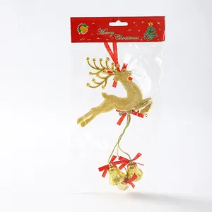 Detail view of golden Christmas reindeer ornament with bells in red packaging