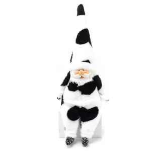 Detail view of a cute plush gnome doll with black and white cow print and resin face