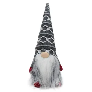 Close-up of a handmade Christmas gnome with grey patterned hat and bushy white beard