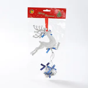 Detailed view of a silver reindeer Christmas ornament featuring bells in retail packaging